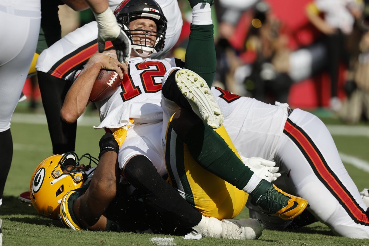 The Packers defense sacks Tom Brady in the 14-12 win